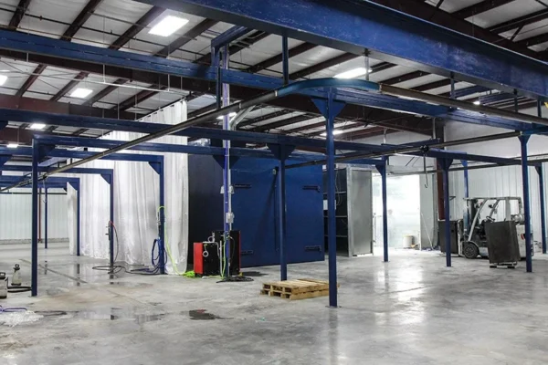 Batch oven installed in a high-bay plant with overhead conveyor track